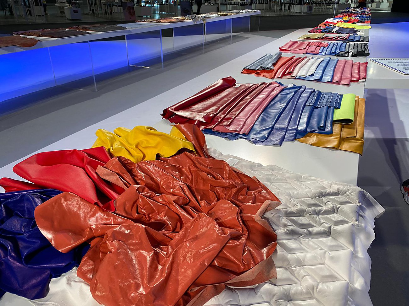 Leather panels laid out on a fair table for selection