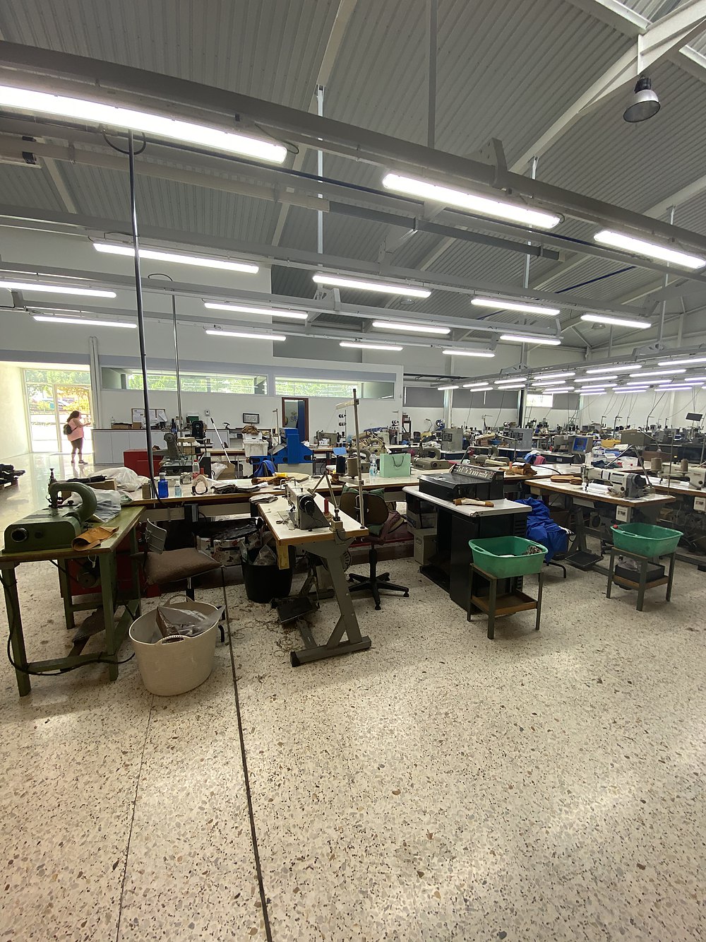 Production hall — rows of sewing stations under the light strips