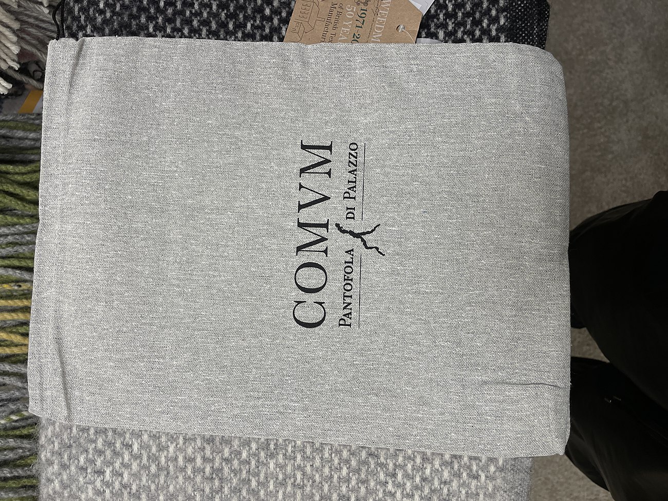 Dust bag with the COMVM wordmark printed