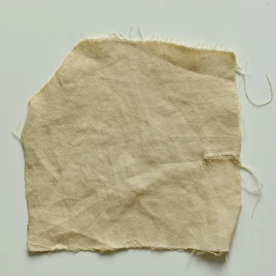 Cotton dyed with pomegranate after an alum mordant &mdash; barely coloured